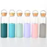 Custom transparent glass water bottle with silicone sleeve and bamboo lid with logo