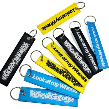 Promotional wholesale custom brand name travel souvenir woven embroidery logo fabric keychains