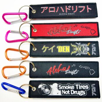 Hot sale promotional custom brand logo embroidery jet tag fabric keyring woven keychain